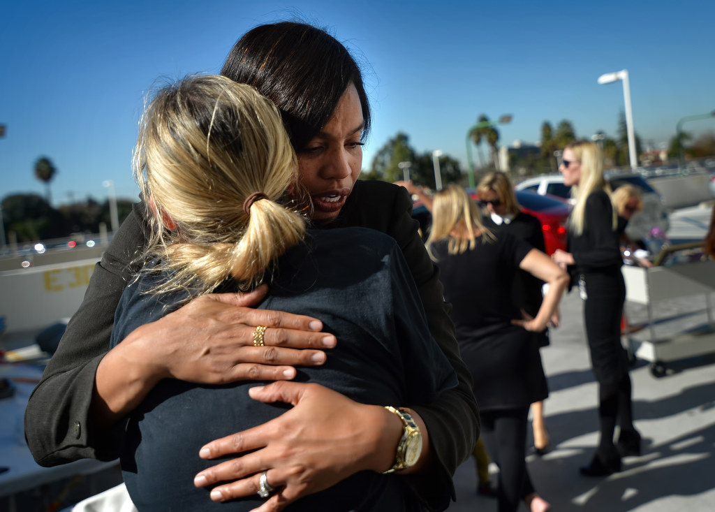 Tamika Williams gets hugs from friends at the conclusion of a small but emotional ceremony honoring her son, 10-year-old Jordan Williams who passed away from Leukemia two years ago, on a patio at the the District Attorney's Office in Santa Ana. Photo by Steven Georges/Behind the Badge OC