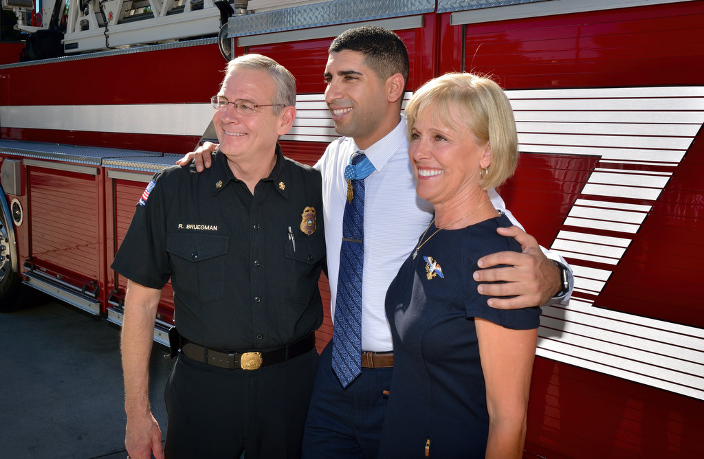 Medal of Honor Recipient Captain Florent Groberg, center with Anaheim Fire and Rescue Chief Randy Bruegman and his wife Susan Bruegman. Photo by Steven Georges/Behind the Badge OC