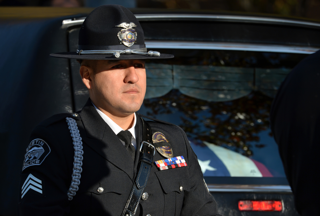 Tustin Sgt. Manny Arzate stands watch over the casket of Downey PD Officer Ricardo "Ricky" Galvez before being brought into the Cathedral of Our Lady of the Angels for funeral services. Photo by Steven Georges/Behind the Badge OC
