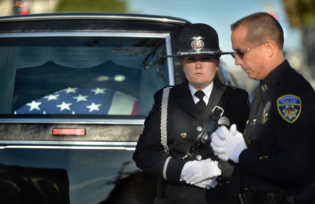 Tustin Sgt. Sara Fetterling stands watch over the casket of Downey PD Officer Ricardo "Ricky" Galvez as Downey Police Capt. Stephen Garza, right, gathers his thoughts at the start of funeral services. Photo by Steven Georges/Behind the Badge OC