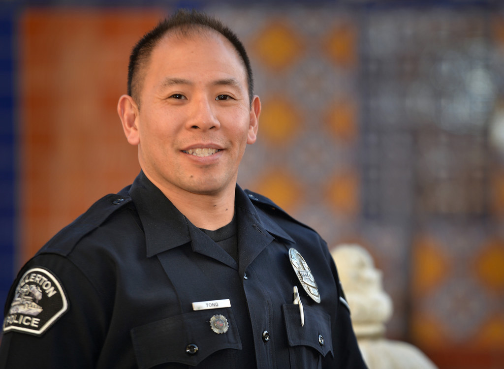 Sgt. Tak Kim is honored with a Walk of Honor at the Fullerton Police Department for his 32 years of service during a retirement gathering.