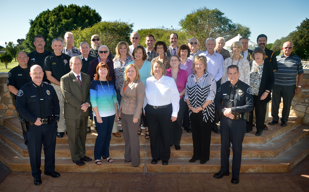 Cypress Police and civic members, including Cypress Police Chief Rod Cox, Mayor Rob Johnson and Mayor Pro Tem Mariellen, stand with CypressÕ volunteers during Cypress PDÕs Volunteer Appreciation Luncheon at the Eagle's Nest Restaurant in Cypress. Photo by Steven Georges/Behind the Badge OC
