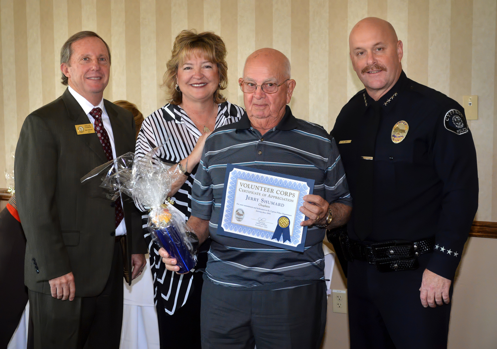 Chaplain Jerry Shumard receives an appreciation award for volunteering from Mayor Rob Johnson, left, Mayor Pro Tem Mariellen Yarc and Cypress Police Chief Rod Cox. Photo by Steven Georges/Behind the Badge OC