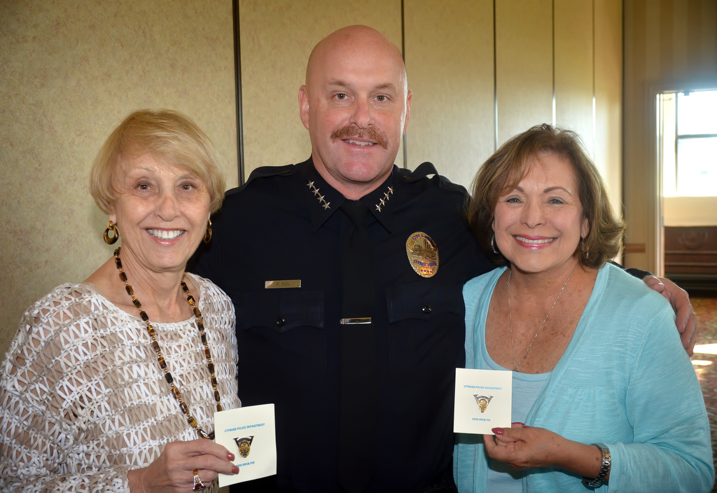 Cypress Police Chief Rod Cox stands next to Arlene Gellerman, left, and Jan Ridgeway who each received their 2500 hour pin during a luncheon honoring Cypress’ volunteers. Photo by Steven Georges/Behind the Badge OC