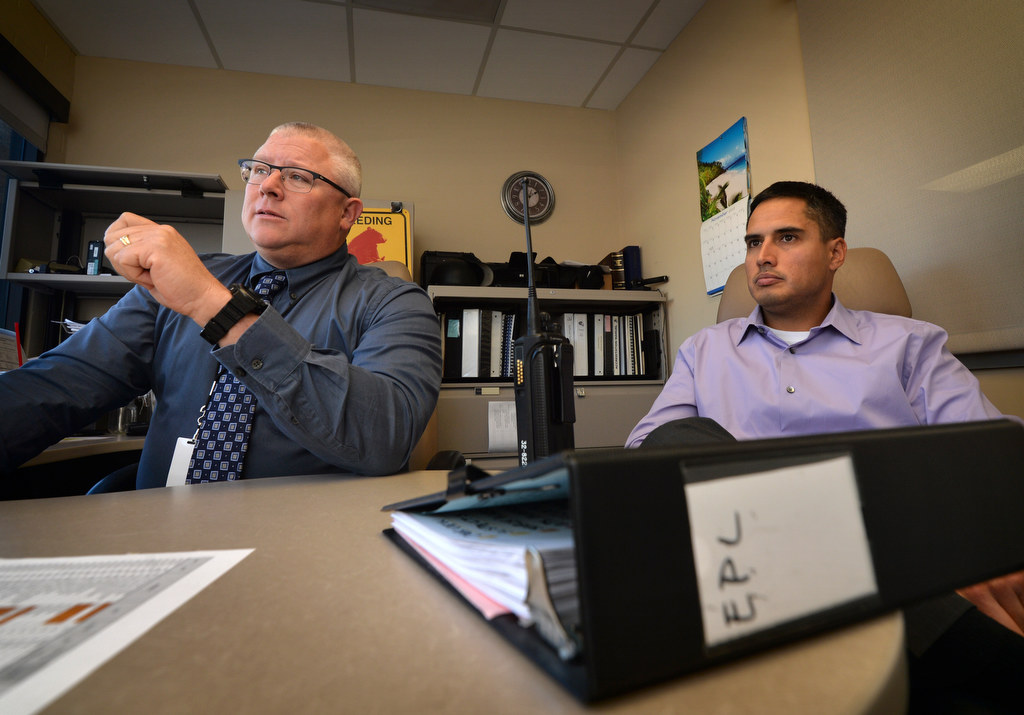 Sgt. Carl Whitney, left, and Detective Dennis Wardle of the Garden Grove PD sit behind the case file book on the serial burglars who targeted El Pollo Loco (EPL) and talk about how they were caught. Photo by Steven Georges/Behind the Badge OC