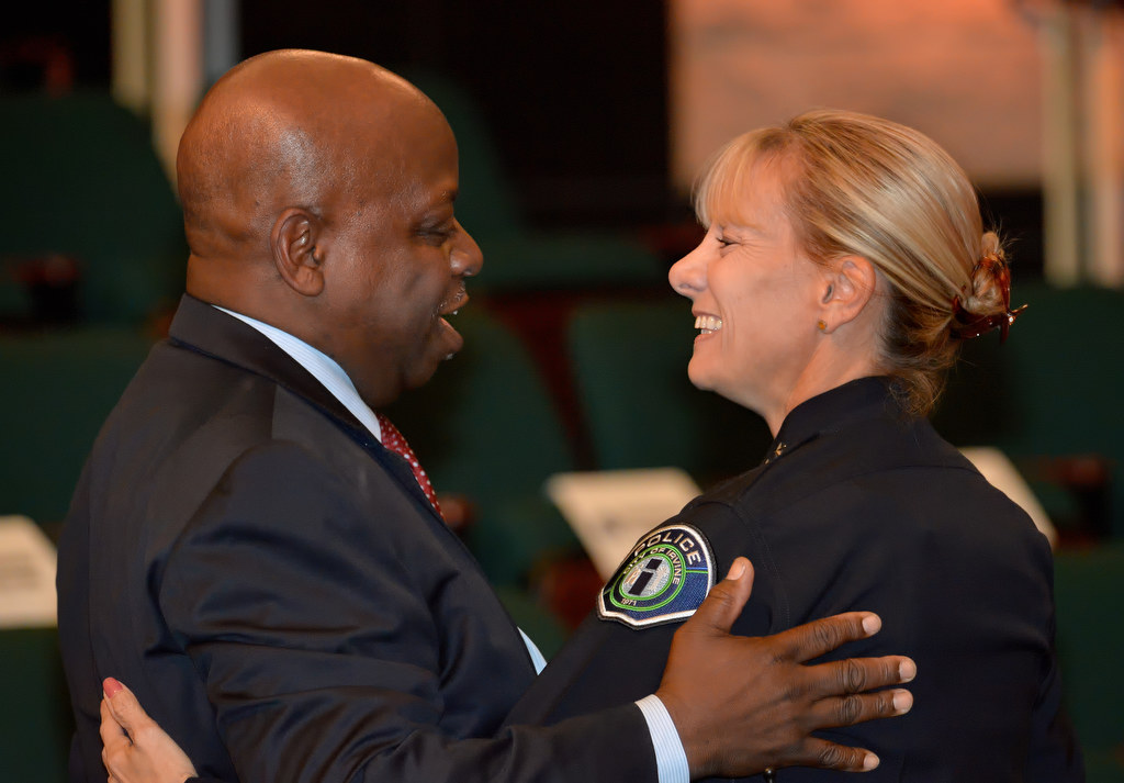 Tustin Mayor and past recipient of the Irvine PD's Medal of Valor, Al Murray, gives Julia Engen a congratulatory hug after she was sworn in as Irvine PD's new deputy chief. Murray is a retired police lieutenant who was with the Irvine PD. Photo by Steven Georges/Behind the Badge OC
