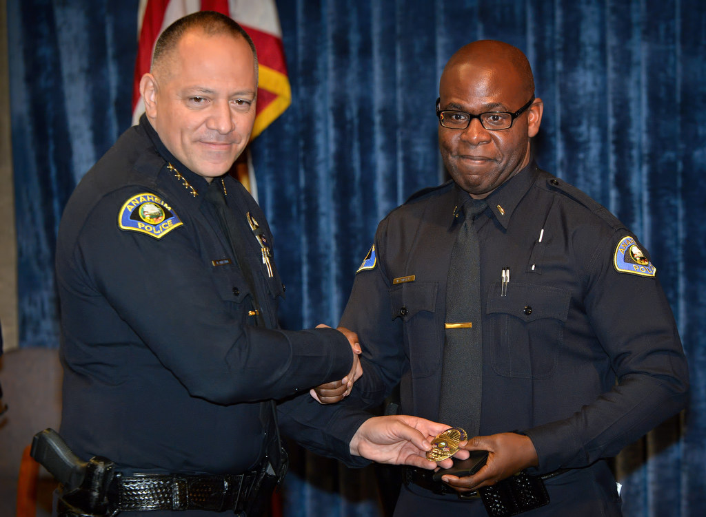 Anaheim Police Chief Raul Quezada, left, presents Willie Triplett II with his new badge for his promotion to Lieutenant during a ceremony. Photo by Steven Georges/Behind the Badge OC