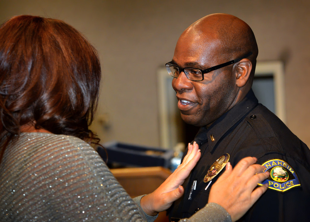 Anaheim PD’s new lieutenant, Willie Triplett II, has his new badge pinned to him by his wife Mirna during a promotion ceremony. Photo by Steven Georges/Behind the Badge OC