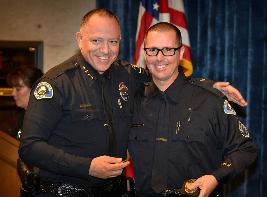 Anaheim Police Chief Raul Quezada, left, presents Brian Paqua with his new badge for his promotion to Sergeant during a ceremony. Photo by Steven Georges/Behind the Badge OC