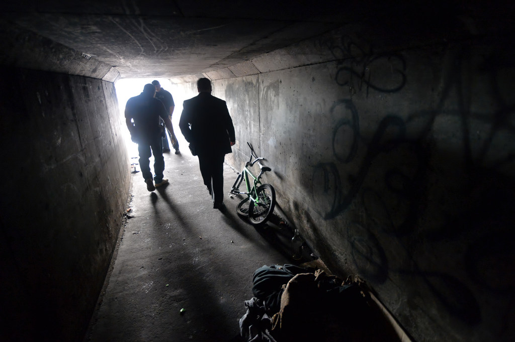 Garden Grove officers walk through the storm drain tunnels under Brookhurst St. where people were living. Photo by Steven Georges/Behind the Badge OC
