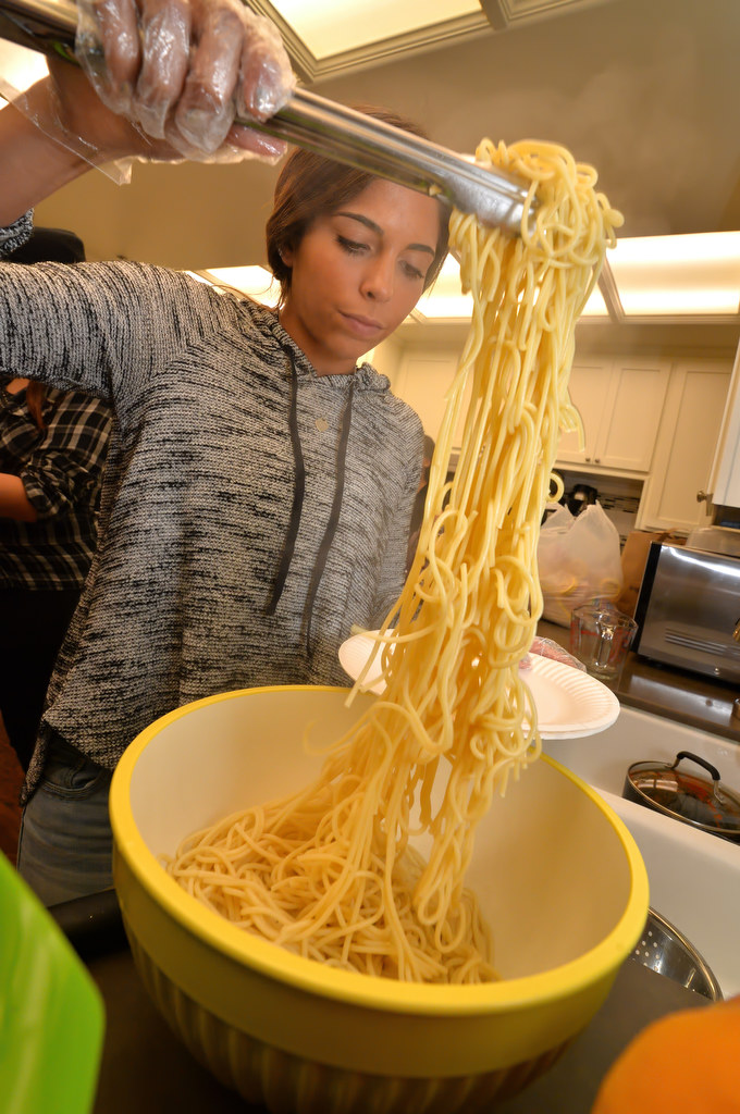 Ana, 17, gets spaghetti dinners for families of CHOC ChildrenÕs Hospital at the Ronald McDonald House in Orange. Photo by Steven Georges/Behind the Badge OC