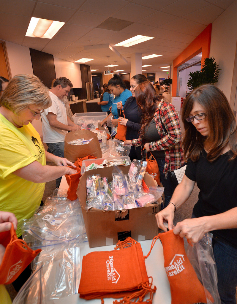 Volunteers assemble women’s HomeAid CareKits that include socks and items for specifically for women. Photo by Steven Georges/Behind the Badge OC