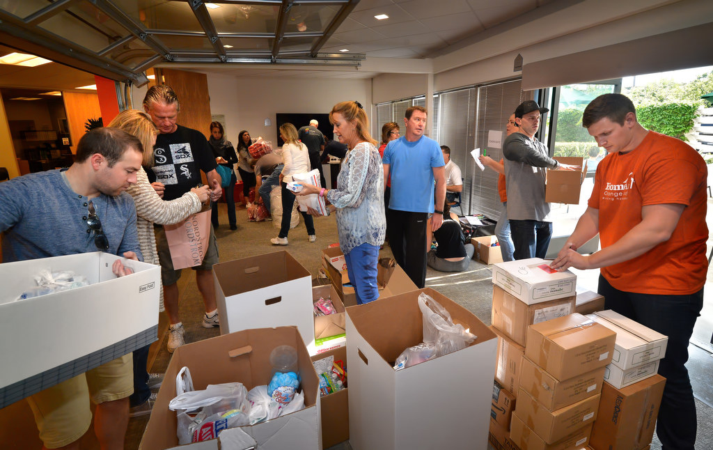 Volunteers unpack boxes of items that will be used to assemble HomeAid CareKits for the homeless and less fortunate. Photo by Steven Georges/Behind the Badge OC