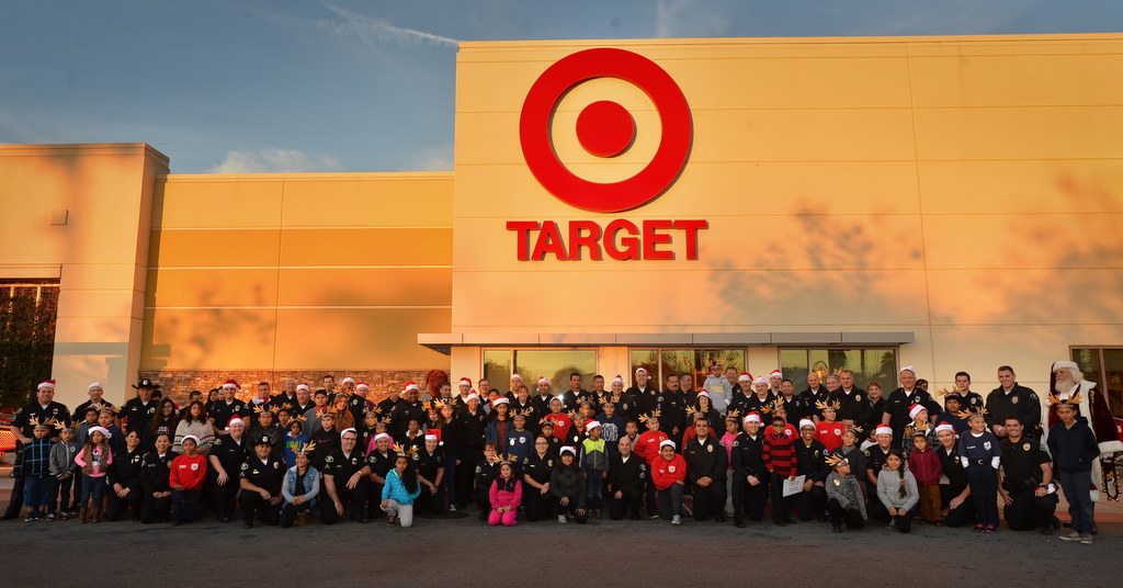 Anaheim PD officers team up with kids in front of the Target store in Anaheim for the annual Shop With a Cop event. Photo by Steven Georges/Behind the Badge OC