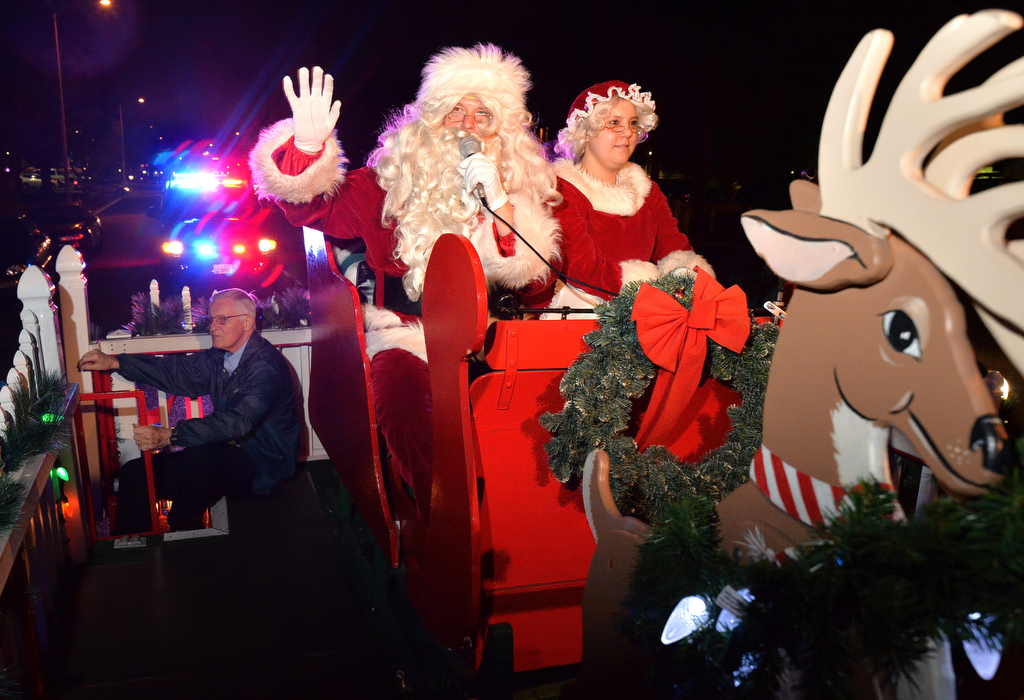 Santa and Mrs. Claus -- played by Tustin PD's Lt. Robert Wright and records specialist Stephanie Distefano -- are escorted on their sleigh down Newport Avenue by the Tustin PD as they visit the neighborhoods of Tustin. Photo by Steven Georges/Behind the Badge OC