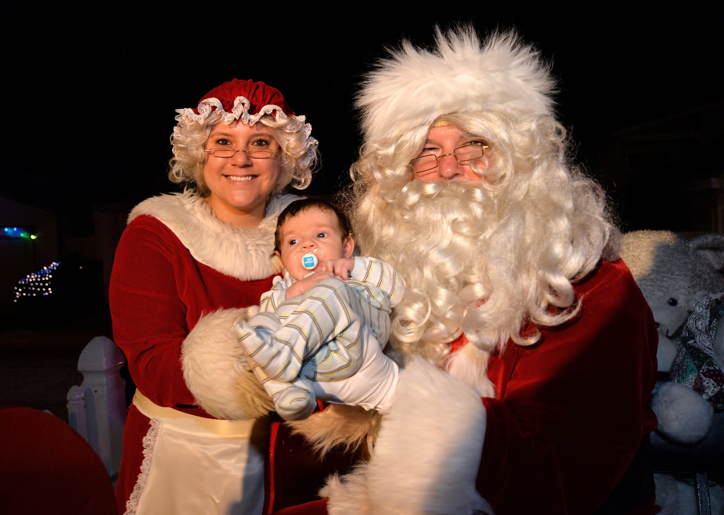 Six-week-old Shepherd Jones has his first Christmas photo taken with Santa and Mrs. Claus as they tour the neighborhoods of Tustin with the Tustin PD. Photo by Steven Georges/Behind the Badge OC
