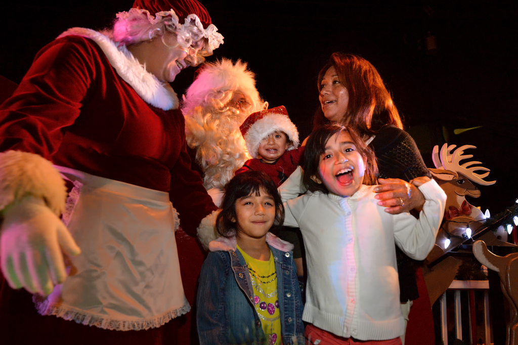 The Garcia family visit Santa and Mrs. Claus during Tustin PD's Santa's Sleigh tour of the neighborhoods in Tustin.  Photo by Steven Georges/Behind the Badge OC