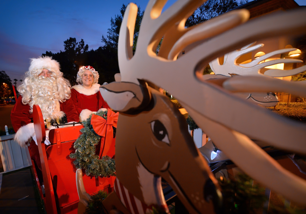 Santa and Mrs. Claus on their sleigh, escorted through the streets and neighborhoods of Tustin by the Tustin PD. Photo by Steven Georges/Behind the Badge OC