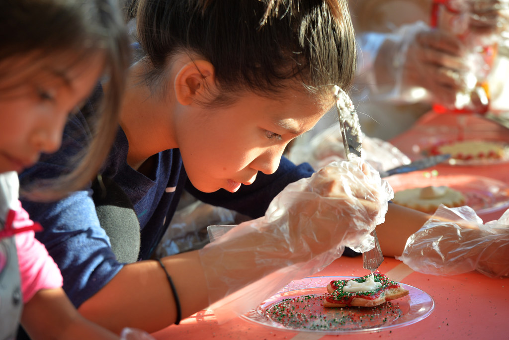 Hellen Nguyen, 10, decorates cookies for the Garden Grove PD, part of a Boys & Girls Club of Garden Grove project at Post Elementary School. Photo by Steven Georges/Behind the Badge OC