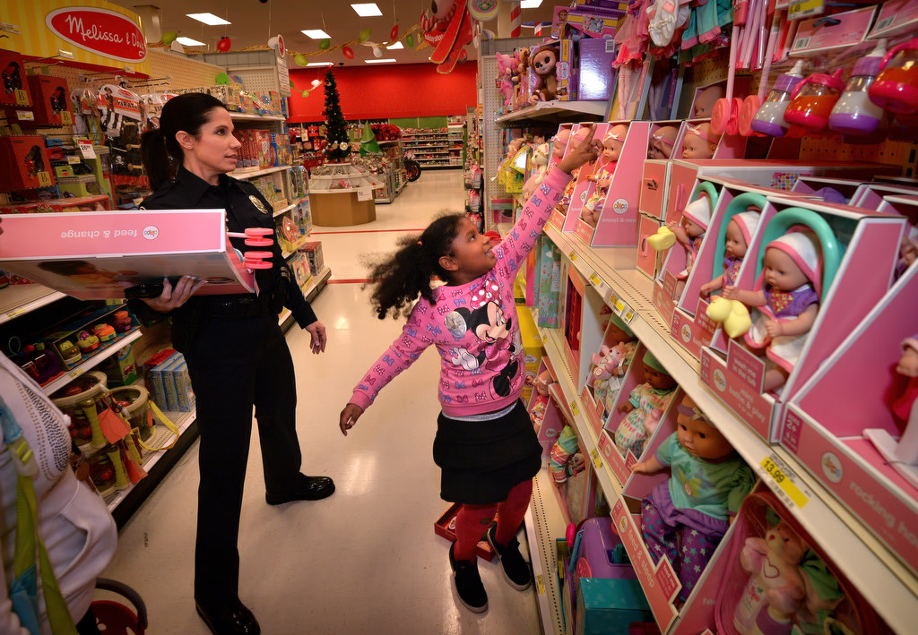 Tatiana Donaldson, 7, picks out a new doll with the help of Sgt. Kathryn Hamel during Fullerton PD’s Shop With a Cop at a local Target store. Photo by Steven Georges/Behind the Badge OC