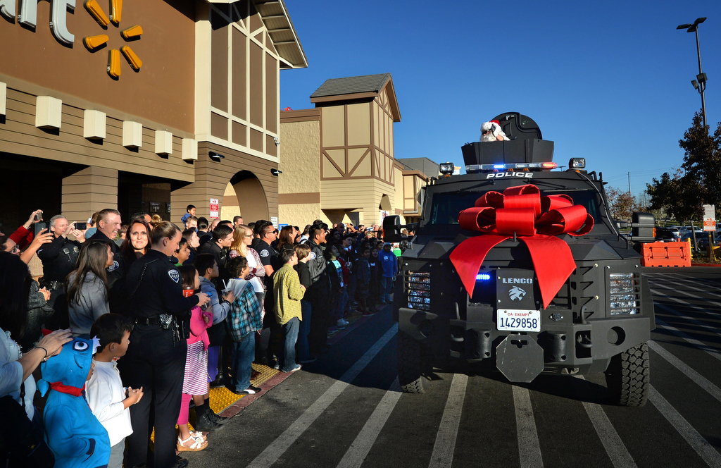 Santa makes a grand entrance as he arrives in a SWAT truck for Westminster PD’s annual Shop With a Cop event at the Walmart in Westminster. Photo by Steven Georges/Behind the Badge OC