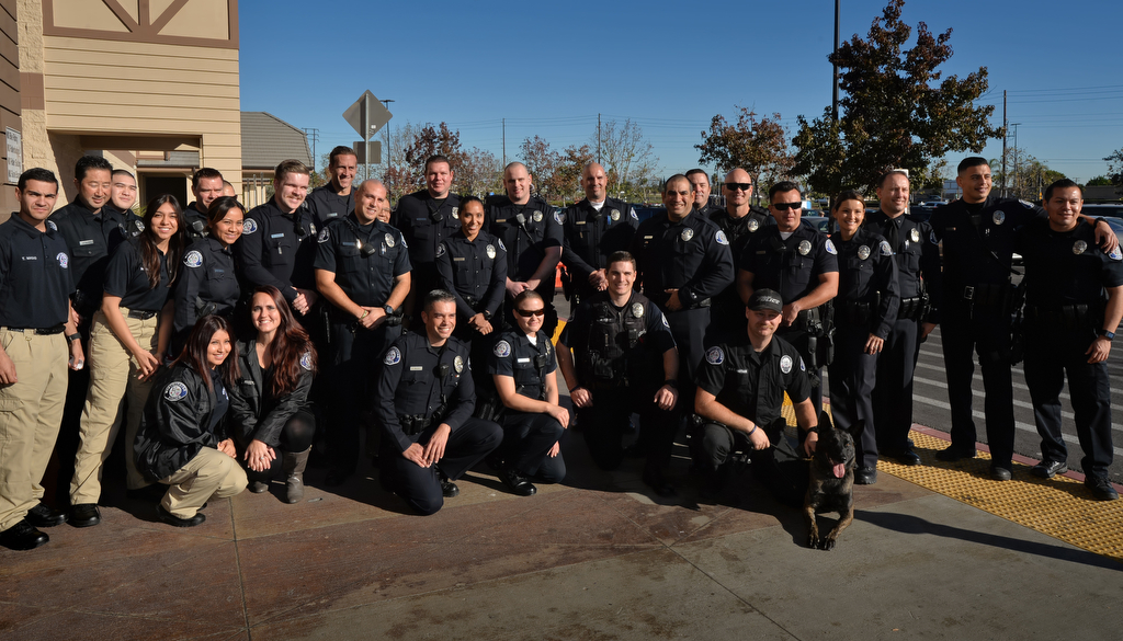 Members of the Westminster PD, including their police dog “Pako”, gather after their annual Shop With a Cop event at the Walmart in Westminster. Photo by Steven Georges/Behind the Badge OC