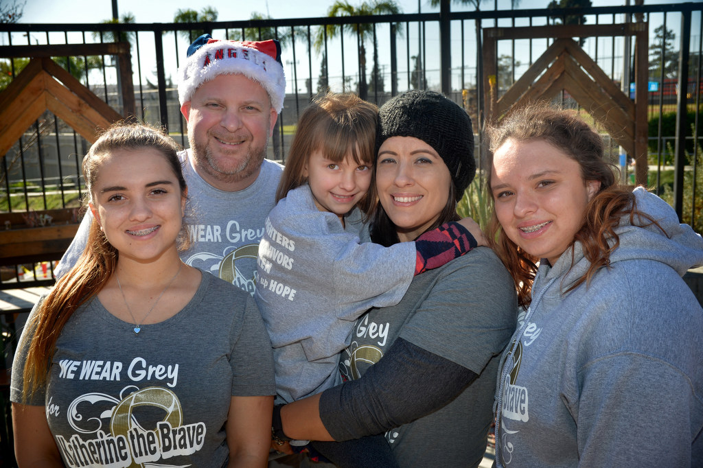 Six-year-old Katherine King, center, who was diagnosed with Diffuse Pontine Intrinsic Glioma (DIPG), an inoperable and incurable brain stem tumor, with her family, Alissa LaShorne, sister, left, David King, dad, Katherine, Jaimee King, mom, and Tori LaShorne, sister, at Bootlegger’s Brewery and the Clothes for the Cause fundraiser. Photo by Steven Georges/Behind the Badge OC