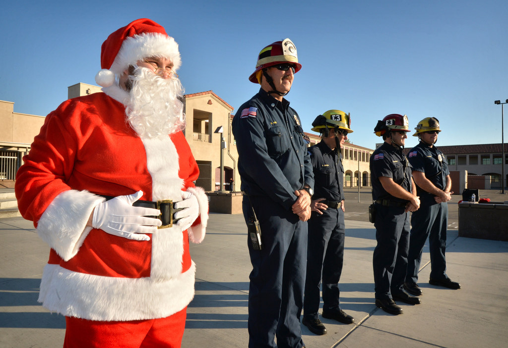 Santa arrives with firefighters from Anaheim Fire & Rescue to Ponderosa Elementary School in Anaheim for an assembly on bicycle safety. Photo by Steven Georges/Behind the Badge OC