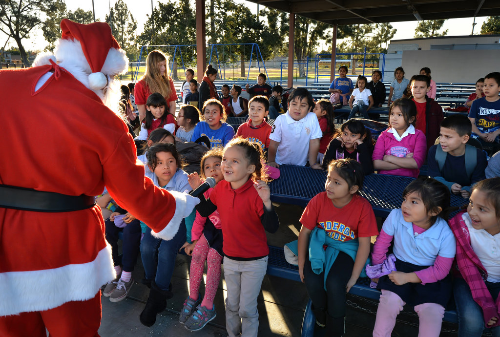 Five-year-old Delylah Torres talksa to santa during a school assembly put on by Anaheim Fire & Rescue on bicycle safety. Photo by Steven Georges/Behind the Badge OC