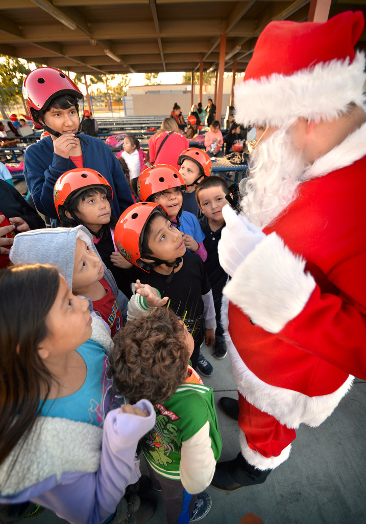Kids from Ponderosa Elementary School gather around Santa with questions during a visit by Anaheim Fire & Rescue for a bicycle safety assembly. Photo by Steven Georges/Behind the Badge OC