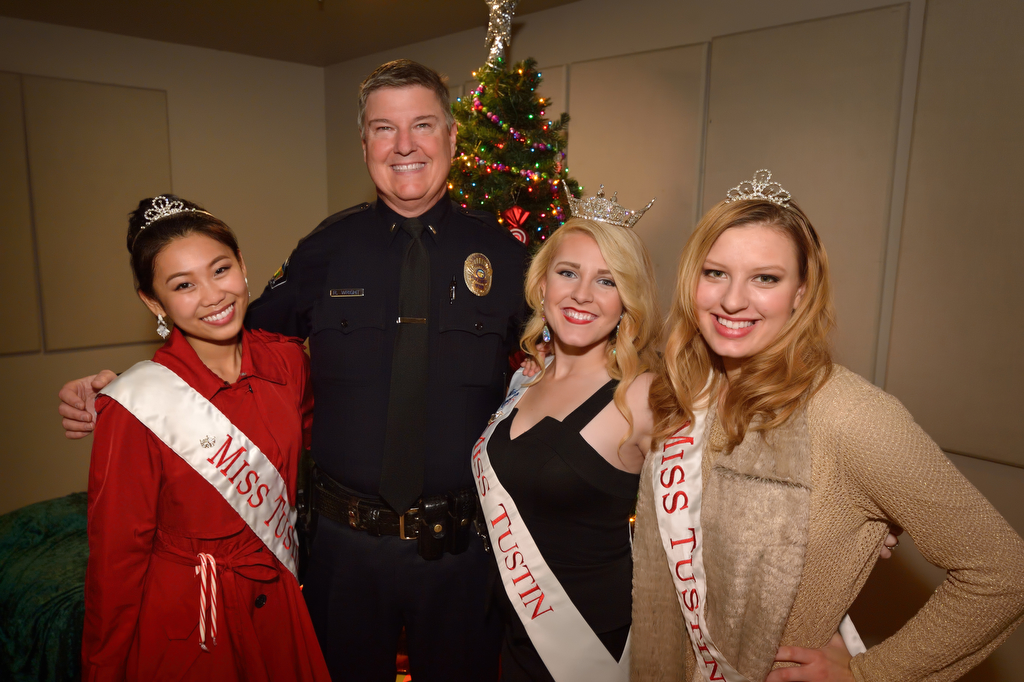 Tustin police Lt. Robert Wright with the Miss Tustin court, 2nd runner up Vivian Strohfus, left, Miss Tustin Danielle Weniger and 1st runner up Jeanay Jensen during Tustin PD’s annual “Santa Cop” at the Tustin Community Center. Photo by Steven Georges/Behind the Badge OC