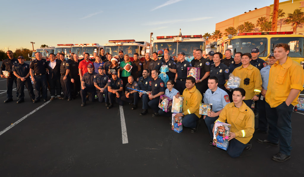 Southland firefighters and other supporters gather in front of fire engines from various departments during the Spark of Love Toy Drive at the Honda Center in Anaheim. Photo by Steven Georges/Behind the Badge OC