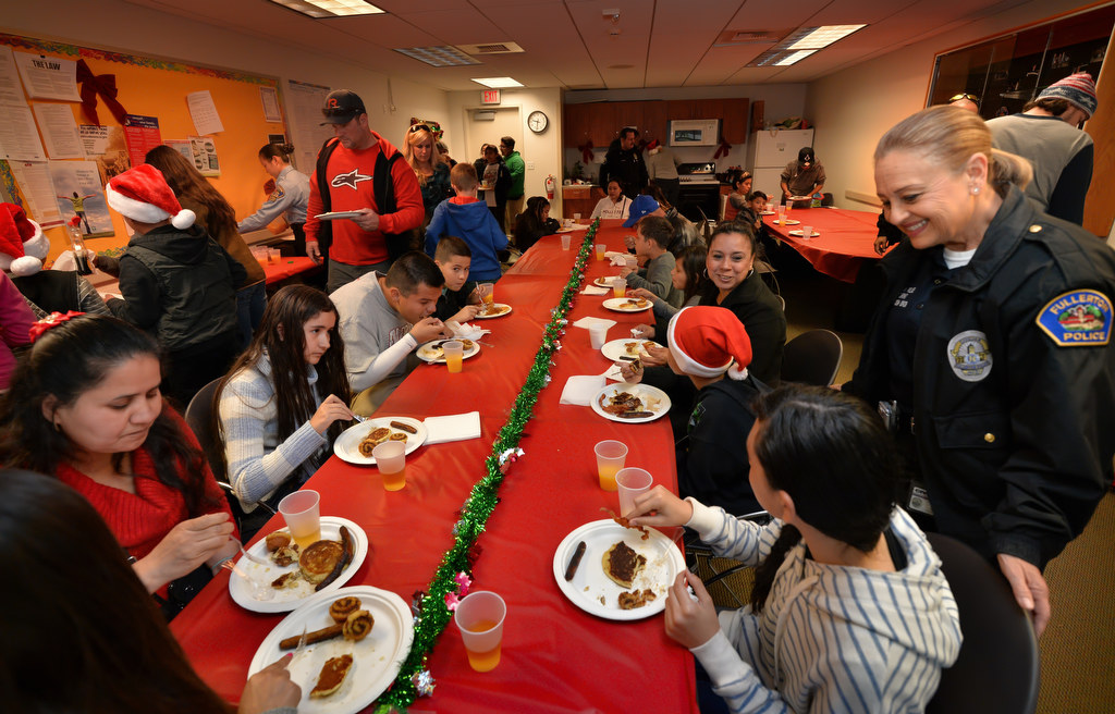 Families enjoy a pancake breakfast at police headquarters during Fullerton PD’s Adopt a Family program before visiting Santa. Photo by Steven Georges/Behind the Badge OC
