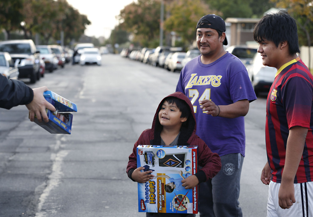 Young Anaheim residents were excited as volunteers and members of the Anaheim Police Department gave toys to local children for Christmas. Photo by Christine Cotter/Behind the Badge OC