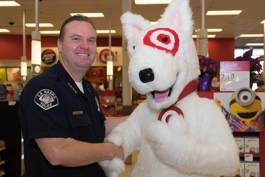 La Habra PD Chief Jerry Price shakes hands with Bullseye, Target's mascot, at the inaugural Heroes & Helpers event.  Photo by Jim Banks/Behind the Badge OC