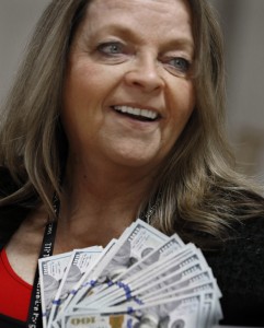 TIP volunteer Margie McInnis is ready to help deliver cash  to needy families in south Orange County. The money was given by an anonymous donor and delivered by the Orange County Sheriff's Department.  Photo by Christine Cotter/Behind the Badge OC