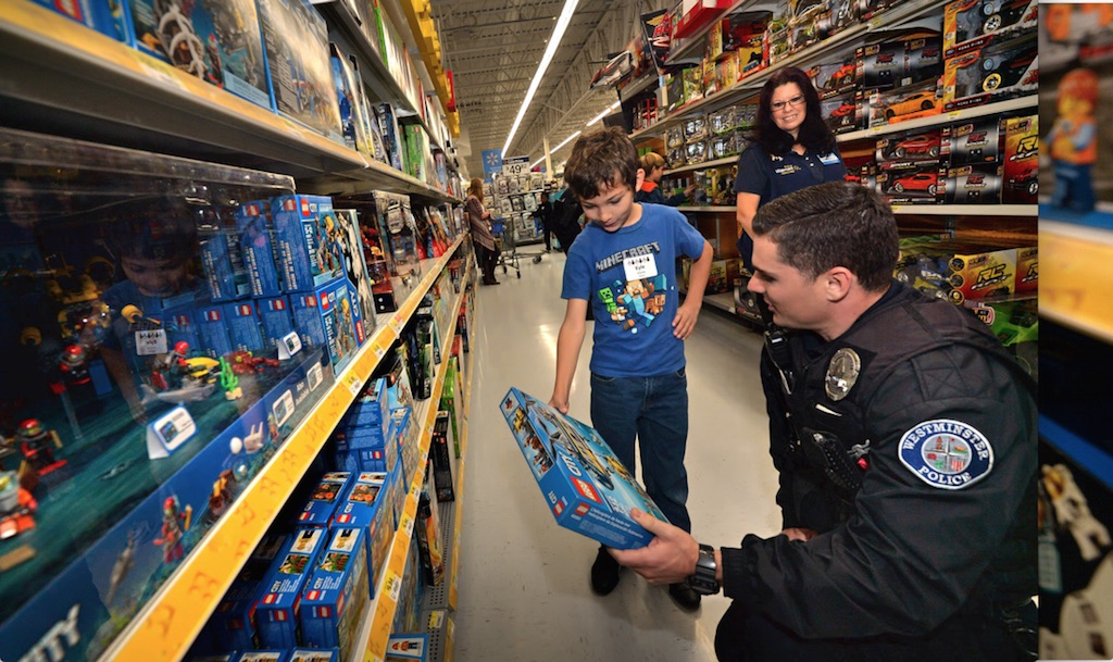 Nine-year-old Kyle Vieira gets help going through the LEGO options during Westminster PD’s annual Shop With a Cop event at the Walmart in Westminster. Photo by Steven Georges/Behind the Badge OC
