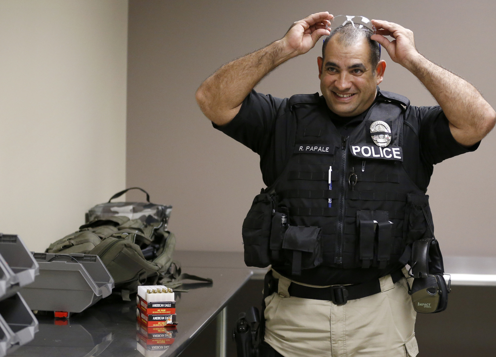 Westminster police detective Rafaelo Papale puts on safety goggles before entering the department's new gun range during a recent open house.  Photo by Christine Cotter/Behind the Badge OC