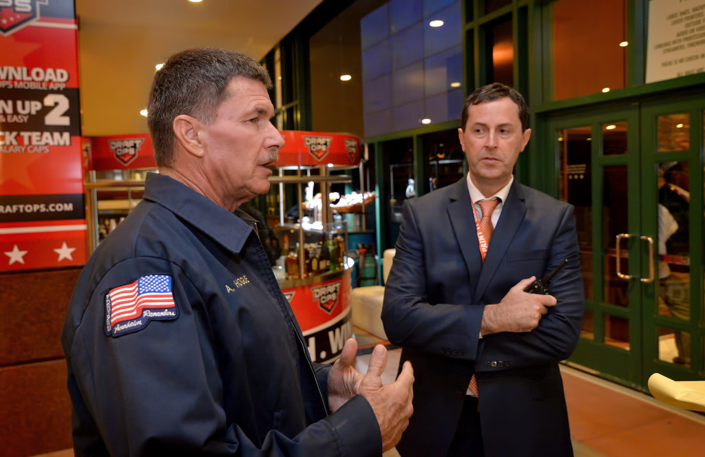 Allen Hogue, assistant fire marshal for Anaheim Fire & Rescue, left, talks about his responsibilities at the Honda Center and what he looks out for during a walking tour with Quinn Mackin, director of events for the Honda Center. Photo by Steven Georges/Behind the Badge OC