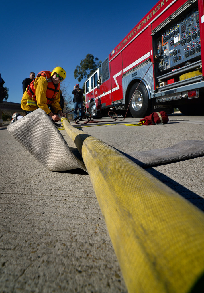 Anaheim firefighters ready a firehose to be filled with air in order to be used as a floating rescue line during a swift water rescue drill. Photo by Steven Georges/Behind the Badge OC