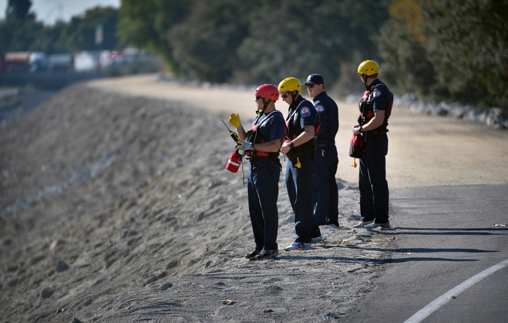 Members of the Orange City Fire Department get ready at the start of a swift water rescue drill at the Santa Ana River at Orangewood Ave. Photo by Steven Georges/Behind the Badge OC