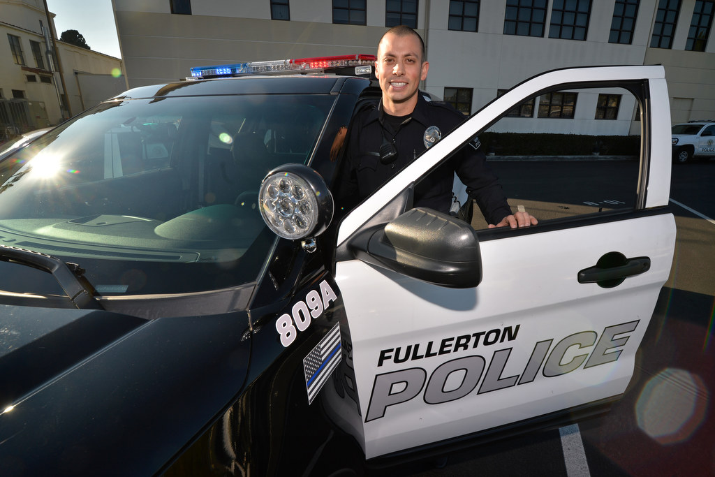 Fullerton Police Officer Marcus Saenz with the new Ford Explorer SUV Interceptor that the department is phasing in and their newly designed Fullerton Police logo that includes the Thin Blue Line American flag decal. Photo by Steven Georges/Behind the Badge OC