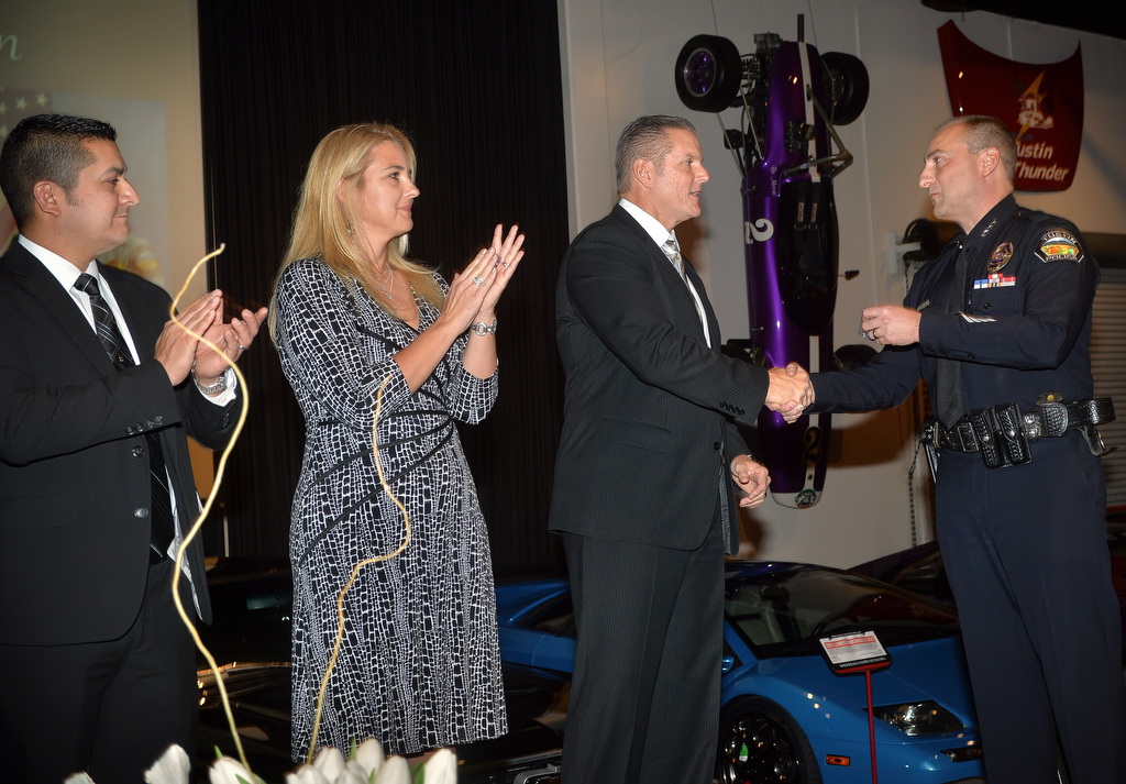 Officer Shonn Rojas, left, Police Crime Analyst Suzanna Howard and Sgt. Del Pickney receive the CTAPS Ribbon from Tustin Police Chief Charles Celano during the Tustin Police Department's Awards Banquet at the Marconi Automotive Museum in Tustin. Photo by Steven Georges/Behind the Badge OC