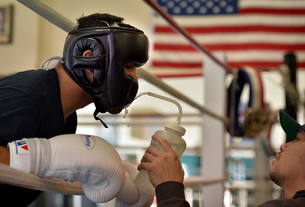 Matt Reily, 21, gets some water between rounds for a sparring session at the Anaheim Boxing Club. Photo by Steven Georges/Behind the Badge OC