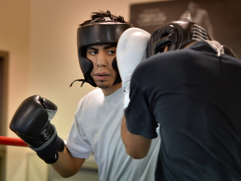 Antonio Garcia, 20, left, spars with Matt Reily at the Anaheim Boxing Club. Photo by Steven Georges/Behind the Badge OC