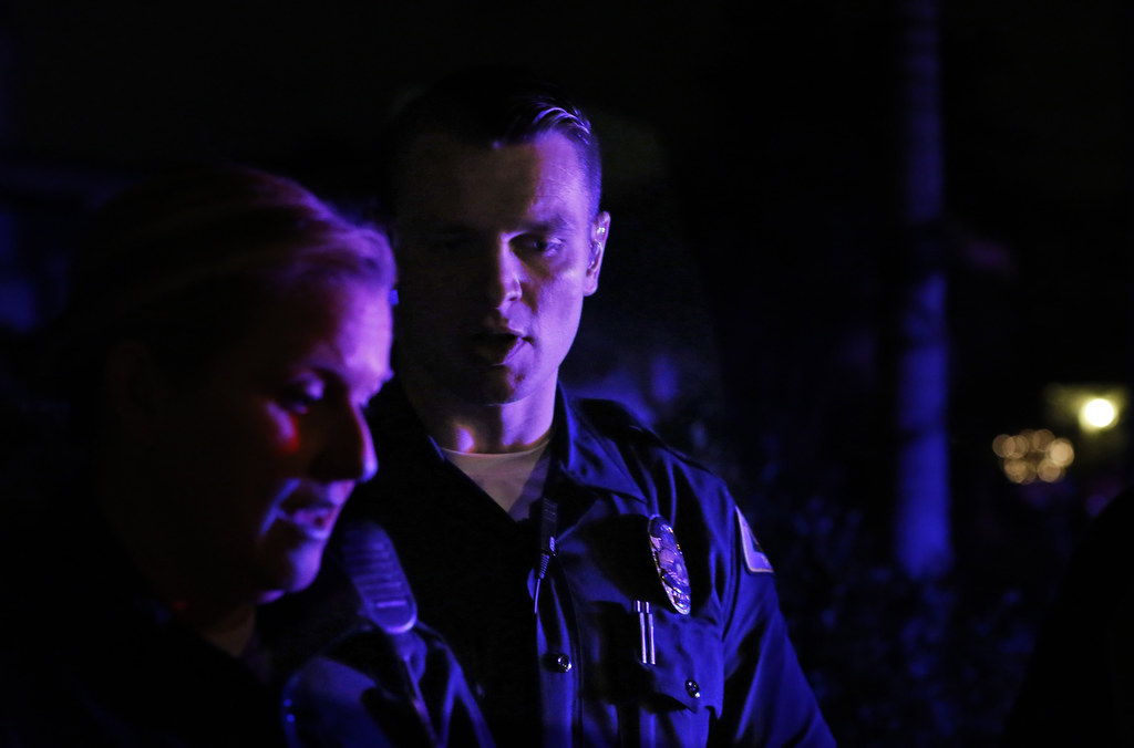 Anaheim Police Department Field Training Officer Kacey Costa goes over a report with trainee Anthony McGlade during a recent graveyard shift. Photo by Christine Cotter/Behind the Badge OC