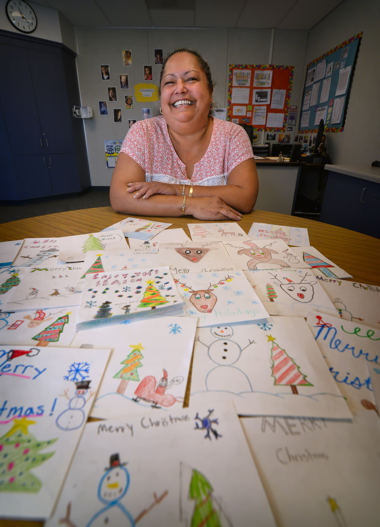 Peggy Kruse with Christmas cards made by the kids from Danbrook Elementary in Anaheim. Photo by Steven Georges/Behind the Badge OC