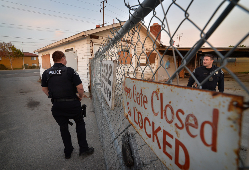 Fullerton PD officers Jose Paez, left, and Chris Murphy check out an abandon building on Orangethorpe Ave. to make sure no one has broke in to use the place. Photo by Steven Georges/Behind the Badge OC
