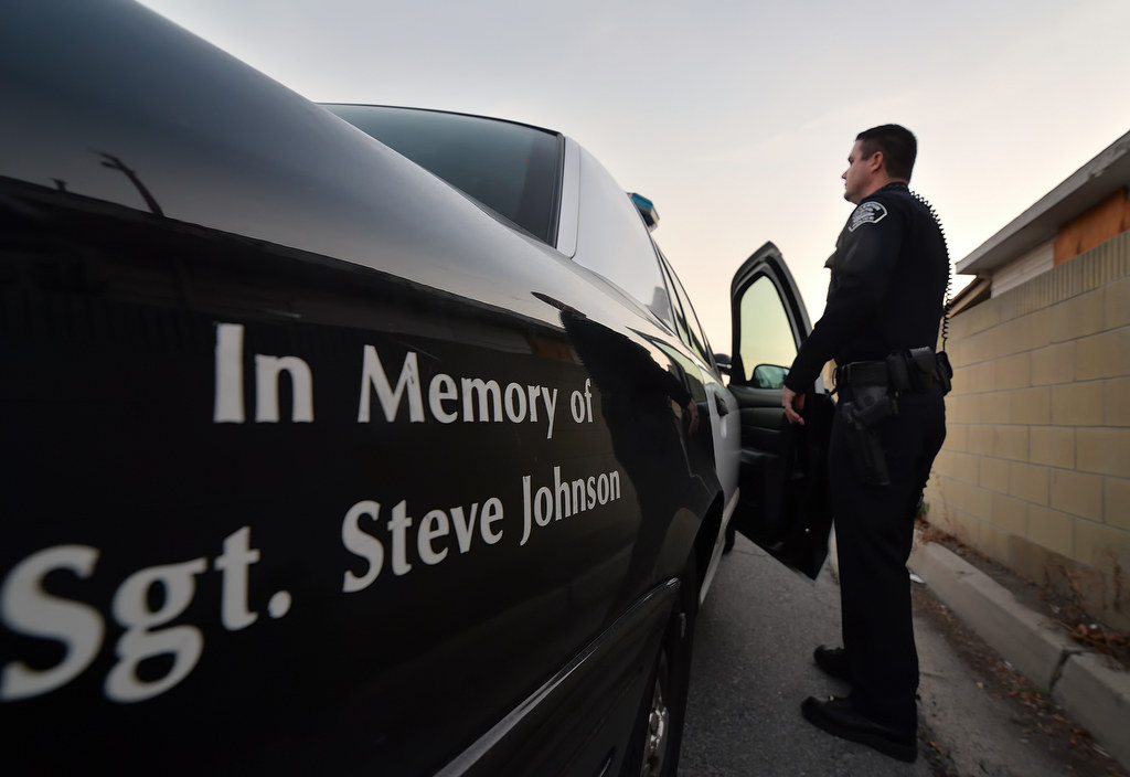Fullerton PD Officer Chris Murphy gets back into a patrol car dedicated to the memory of Sgt. Steve Johnson. Photo by Steven Georges/Behind the Badge OC