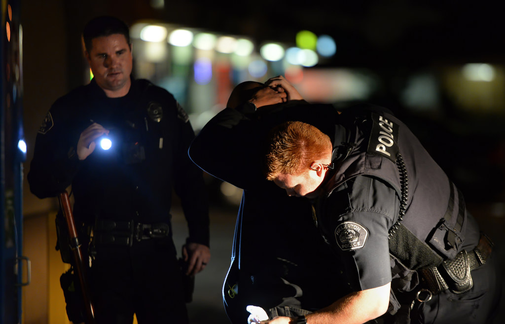 Fullerton PD officers Chris Murphy, left, and Jose Paez perform a safety search while on patrol at Orangethorpe Ave. and Acacia Ave. in Fullerton. Photo by Steven Georges/Behind the Badge OC